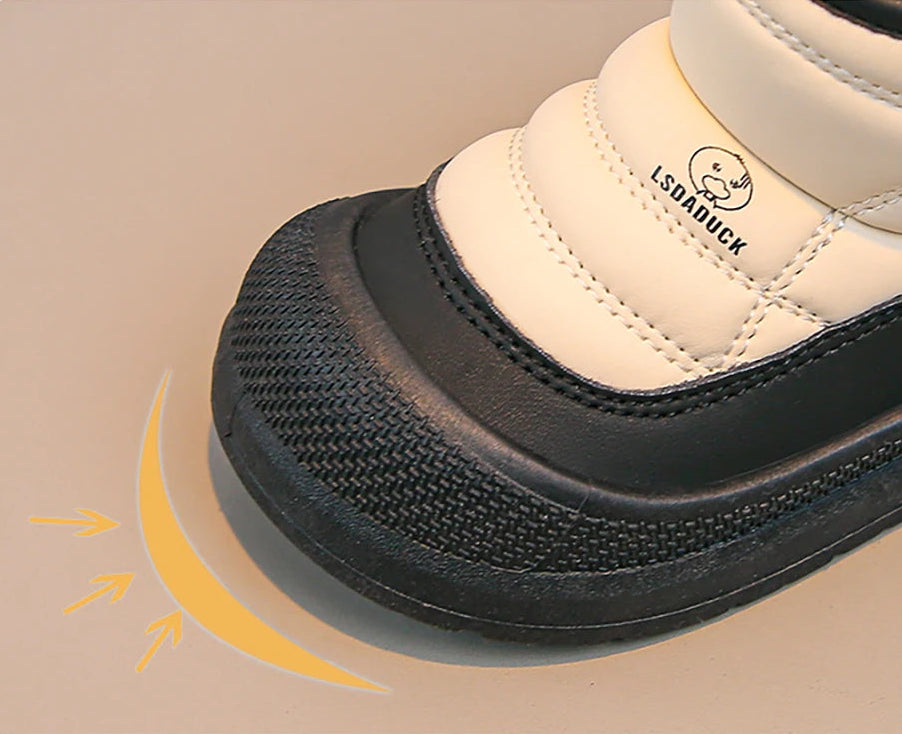 White shoe with black sole on a beige background.