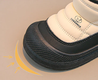 White shoe with black sole on a beige background.