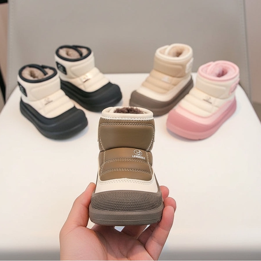 Set of children's snow boots in various colors on a white surface.