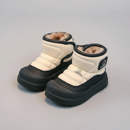 Pair of white children's snow boots with black soles on a light gray background